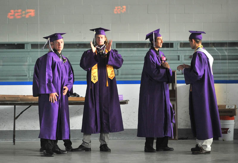 Staff Photo by Michael G. Seamans Waterville Senior High School graduates wait at Alfond Rink before commencement ceremonies at Wadsworth Gymnasium at Colby College in Waterville Thursday.