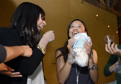 Jessica Nguyen, right, reacts after smelling a shirt as Angela Abad-Santos looks on during a pheromone party in Los Angeles