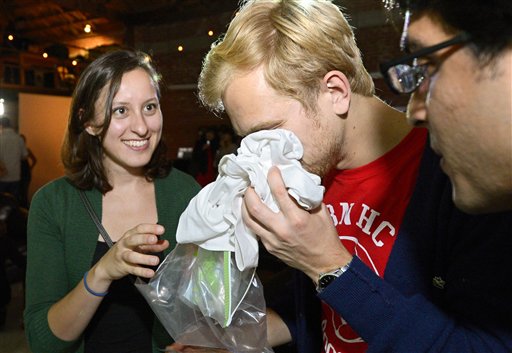 Konstantin Bakhurin smells a shirt as Martina Desalvo, left, and Neelroop Parikfhak look on during a pheromone party recently in Los Angeles.