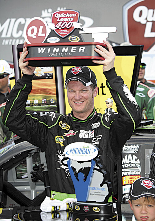 FINALLY: Dale Earnhardt Jr. lifts the trophy after winning the NASCAR Sprint Cup Series Quicken Loans 400 at Michigan International Speedway on Sunday in Brooklyn, Mich. It was Earnhardt’s first win in four years.