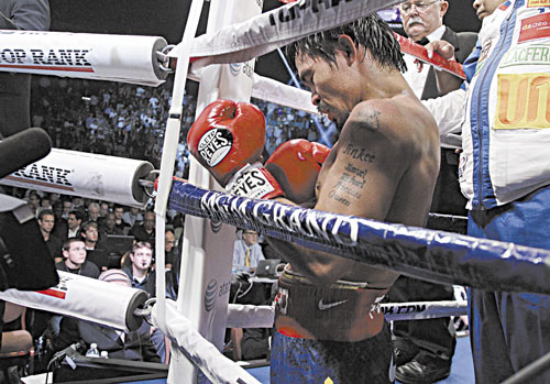 TOUGH LOSS: Manny Pacquiao kneels in his corner following his split decision loss to Timothy Bradley in their WBO world welterweight title fight Saturday in Las Vegas.