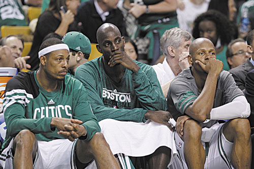 COMING BACK? Boston’s Paul Pierce, left, Kevin Garnett, center, and Ray Allen, right, sit on the bench near the end of the fourth quarter of Game 6 against the Miami Heat in their Eastern Conference finals playoff series Thursday in Boston. Pierce will be back next season but Garnett and Allen are eligible for free agency.