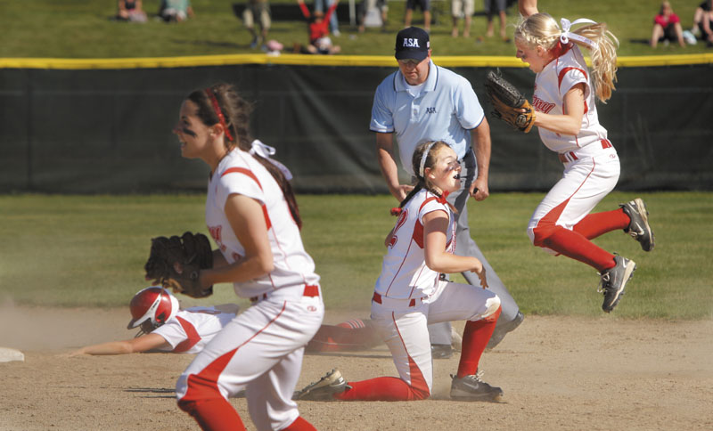 YES: Cony’s Alyssa Brochu, right, jumps into the air in after Alyssah Dennett, center, tagged Danica Gleason of South Portland out at second base for the last out in the Class A softball state championship game Saturday at St. Joseph’s College in Standish. Cony finished its perfect season with a 2-0 win over South Portland.