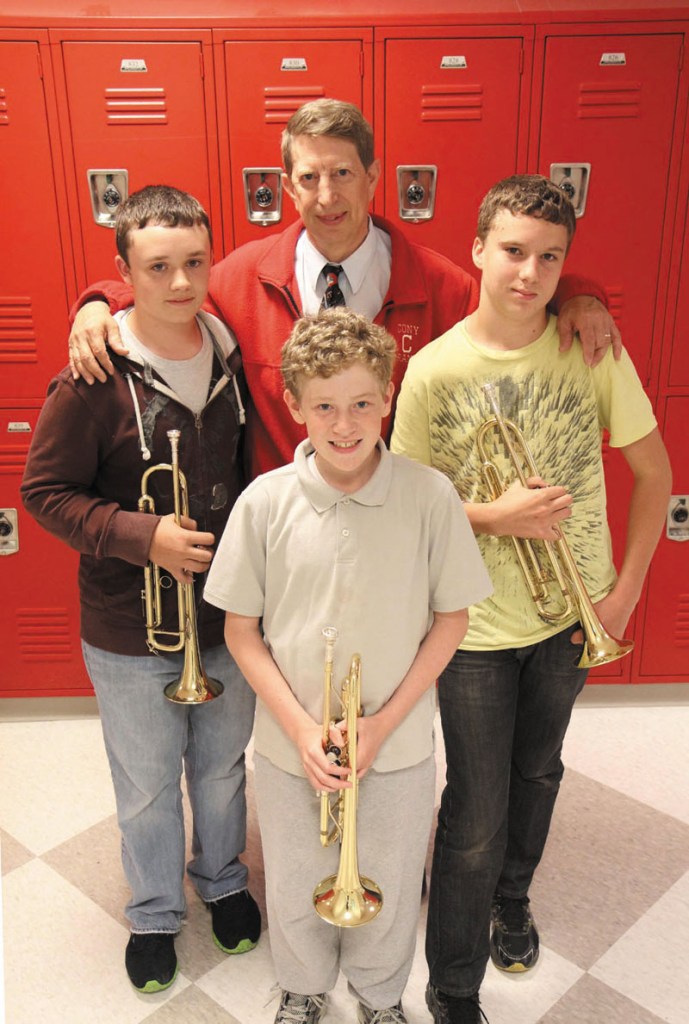 MUSIC MAN: Cony band director Dwight Tibbetts is retiring after 32 years. His band, which includes Patrick Greene, left, Aaron Gray, front, and Noah Guerrette, right, will perform its spring concert — Tibbetts last — Monday night in the William and Elsie Viles Auditorium.