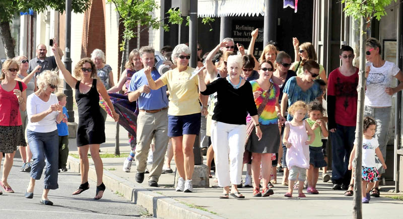 LET'S BOOGIE: Many heads turned as a group of enthusiastic people walked, danced and shook down Main Street in Waterville on Friday doing the dancewalking workout designed for exercise, fun and socializing. Mayor Karen Heck, far right, also participated.