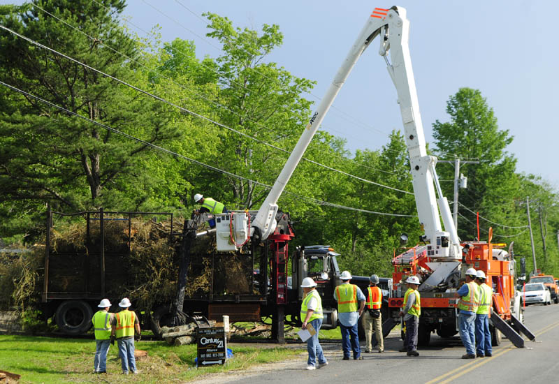 Investigators take measurements of the logging truck where a man was electrocuted on Spears Corner Road in West Gardiner on Friday afternoon. Ronald M. Hickey, 53, was working as an independent contractor for Central Maine Power to clear utility lines when the deadly incident occurred, according to Deputy Aaron Moody of the Kennebec County Sheriff's Office.