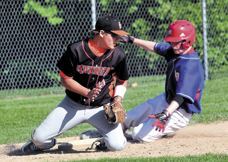 Staff photo by David Leaming Skowhegan's Kam Nelson gets Messalonskee's Trevor Gettig out at third base during game in Skowhegan on Monday.