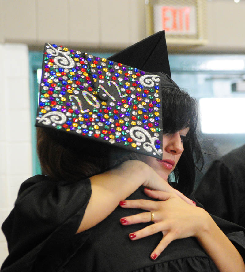 Haley Jaramillo, left, hugs classmate Shyanne Bryant before Hall-Dale High School graduation on Saturday evening at the school in Farmingdale.