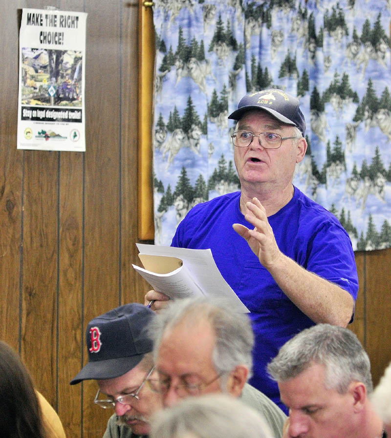Howard Campbell joins in the debate of an ordinance banning fireworks during Litchfield's town meeting on Saturday afternoon.