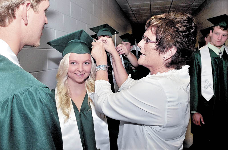 MOVING ON: Retiring Mount View High School English teacher Tanya Hubbard straightens the tassel on graduate Kelsey Higgins during graduation in Thorndike on Sunday. "She is awesome and my favorite teacher," Higgins said.