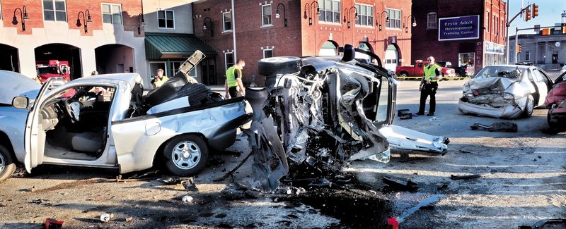 CRASH: Police look over the scene of a six-car accident on College Avenue in Waterville on March 18. The driver charged with causing the accident is in jail after she was indicted by a grand jury.