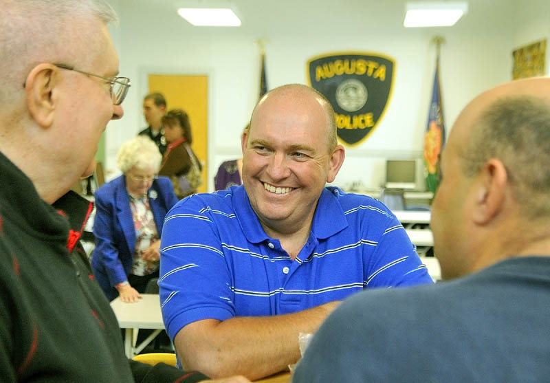 Retiring Augusta Police patrolman Lindell Cox, center, chats with department chaplain Don Williams, left, and Sgt. Richard Dubois on Wednesday morning at his retirement party in Augusta.