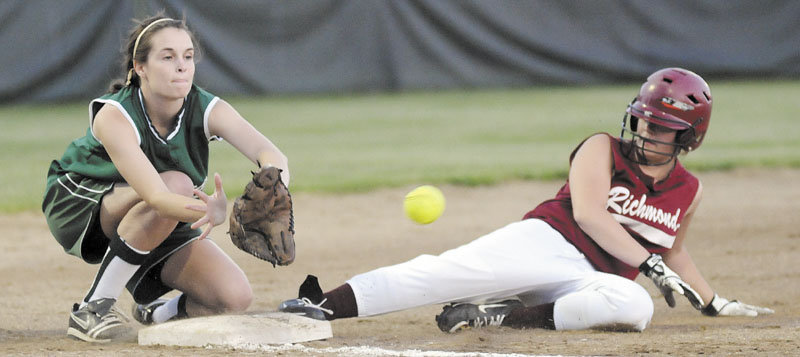 Staff photo by Andy Molloy Richmond High School’s Payton Johnson slides into third base ahead of a throw to Rangeley Lakes Regional High School’s Emily Carrier during the Western D softball regional final Thursday in Standish.
