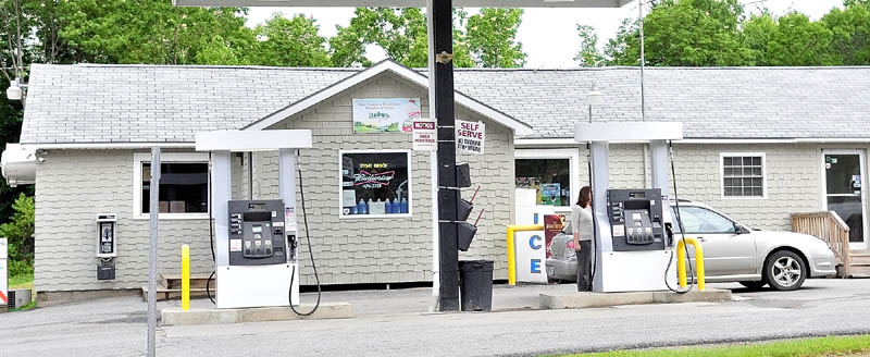 A customer pumps gas outside the Stony Brook Market in Skowhegan on Wednesday. Police are investigating an armed robbery that happened at the store Tuesday evening.