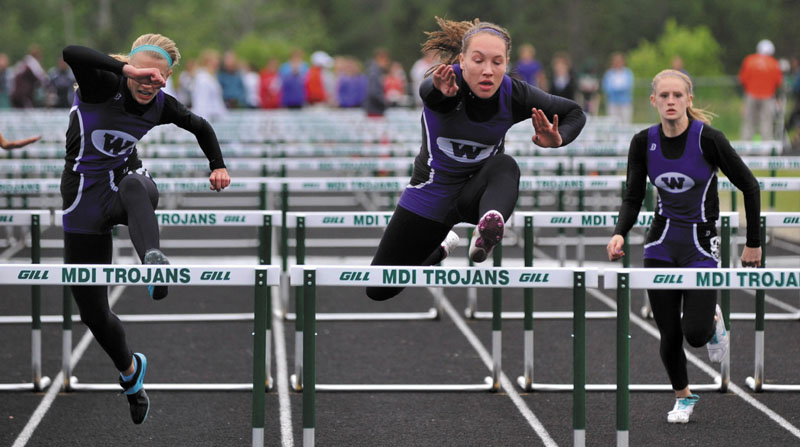 Waterville Senior High School's from left to right Olivia Thurston, Alex Jenson and Sarah Shoulta compete in the championship heat of the 100 meter hurdles.