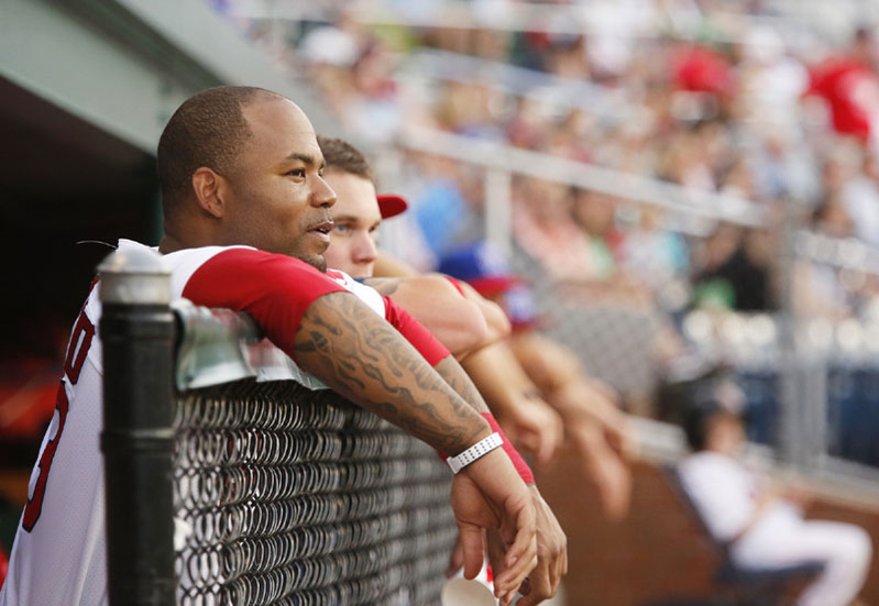 Red Sox outfielder Carl Crawford watches the action from the dugout at a Portland Sea Dogs game on July 3.