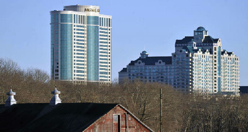 In this March 2012 file photo, Foxwoods Resorts Casino and MGM Grand at Foxwoods loom behind a barn in Mashantucket, Conn.