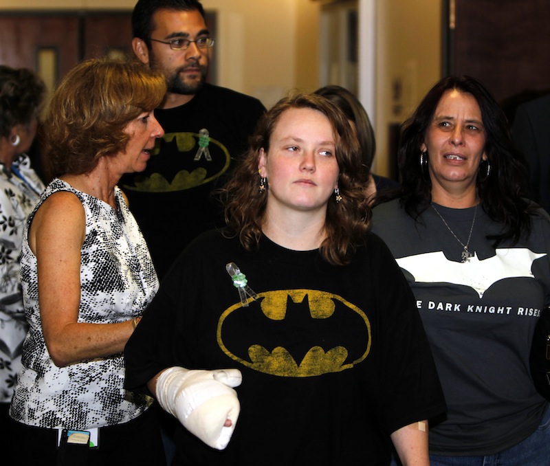 Victims are assisted by an advocate, left, as they arrive for an arraignment for suspected theater shooter James Holmes in district court in Centennial, Colo., on Monday, July 30, 2012. Holmes has been charged in the shooting at the Aurora theater on July 20 that killed twelve people and injured more than 50.He is scheduled to appear in court Monday morning. (AP Photo/Ed Andrieski)