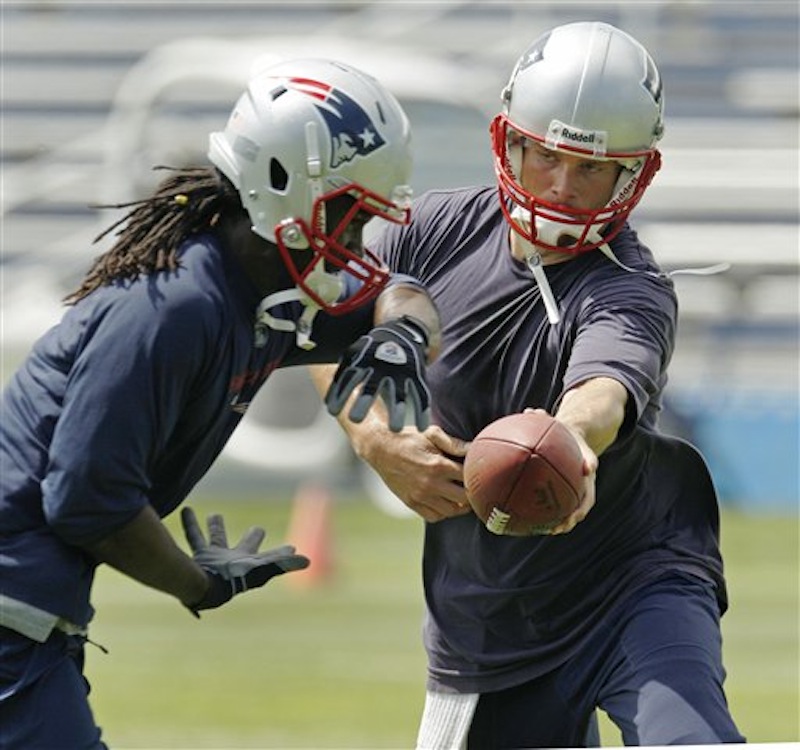 New England Patriots quarterback Tom Brady hands off to running back Joseph Addai during an NFL football team workout in Foxborough, Mass., Thursday, May 24, 2012. The Patriots cut Addai on Wednesday, July 25, 2012. (AP Photo/Charles Krupa)