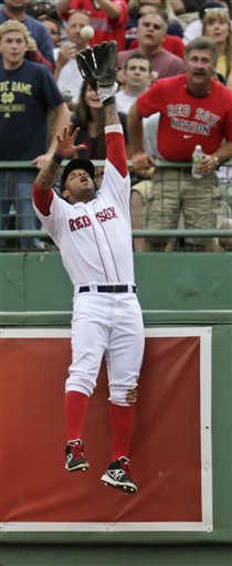 Boston Red Sox left fielder Darnell McDonald makes the catch at the bullpen wall to rob Toronto Blue Jays Kelly Johnson of a home run during the ninth inning of a baseball game at Fenway Park in Boston on June 27, 2012.