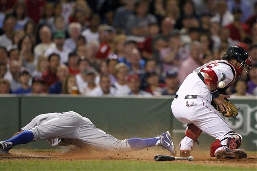 Toronto Blue Jays' Rajai Davis, left, is safe at home plate as Boston Red Sox's Jarrod Saltalamacchia, right, bobbles the throw on a single by the Blue Jays' Brett Lawrie in the seventh inning of a baseball game in Boston, Saturday, July 21, 2012. (AP Photo/Michael Dwyer)