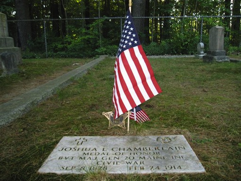 This July 12, 2012 photo shows the plaque at the gravesite in Pine Grove Cemetery in Brunswick, Maine, where Joshua Chamberlain is buried. During the Civil War, Chamberlain led Union forces during the Little Round Top victory at the Battle of Gettysburg and later accepted the Confederacy surrender at Appomattox in Virginia. (AP Photo/Beth Harpaz)