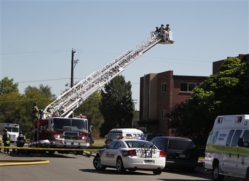 Police use the bucket on a fire truck to look down on an apartment where the suspect in a theatre shooting lived in Aurora, Colo., on Friday, July 20, 2012. As many as 12 people were killed and 50 injured at a shooting at the Century 16 movie theatre on Friday. The suspect is identified as 24-year-old James Holmes. (AP Photo/Ed Andrieski)