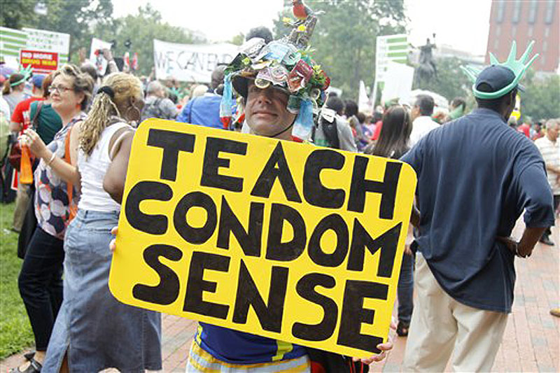 People gather near the White House in Washington, Tuesday, July 24, 2012, during an AIDS demonstration, Tuesday, July 24, 2012, as the AIDS conference continued in Washington. (AP Photo/Haraz N. Ghanbari)