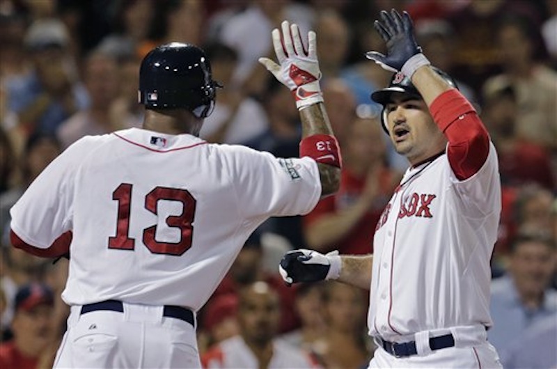 Boston Red Sox's Adrian Gonzalez, right, is congratulated by Carl Crawford on his three-run home run in the eighth inning of a baseball game against the Chicago White Sox at Fenway Park in Boston, Monday, July 16, 2012. (AP Photo/Charles Krupa)