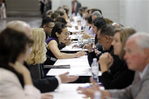 Job seekers have their resumes reviewed at a job fair expo in Anaheim, Calif., recently. The June unemployment rate was unchanged at 8.2 percent, the Labor Department said today.