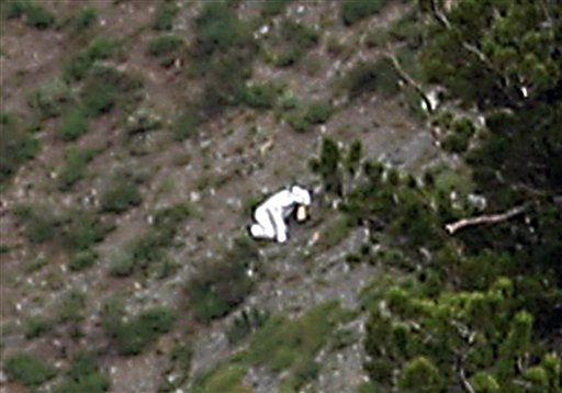 In this Sunday, July 15, photo, a person is seen in a goat suit in the Wasatch Mountains on Ben Lomond peak outside of Ogden, Utah.