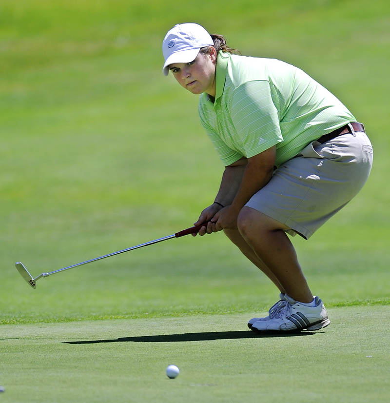 STAFF PHOTO BY ANDY MOLLOY COME BACK KID: Emily Bouchard watches a putt Wednesday during the third day of the Maine Women's Amateur golf tournament at the Augusta Country Club in Manchester.
