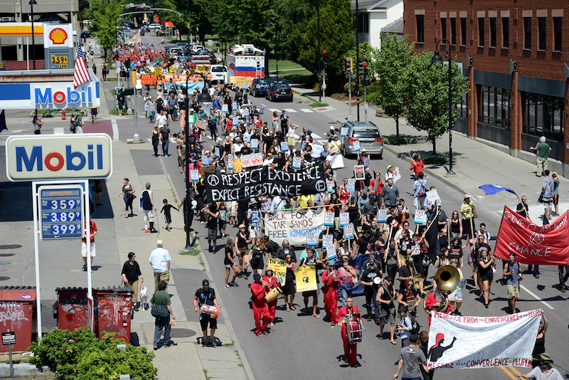 Hundreds of protesters march down South Winooski Avenue in Burlington, Vt., during demonstrations on Sunday, July 29, 2012, as the 36th Annual Conference of New England Governors and Eastern Canadian Premiers set up at the hotel.