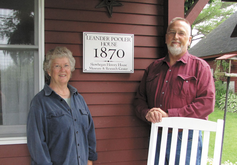 Mary Lou Holden and Henry Mollerus stand in front of their historic home on Parkman HIll in Skowhegan.