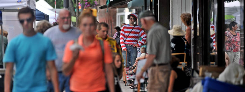 David Gulak, center, dressed as Waldo, from the popular children's book series, "Where's Waldo?" is spotted at the Waterville Intown Arts Festival on Main Street on Saturday.