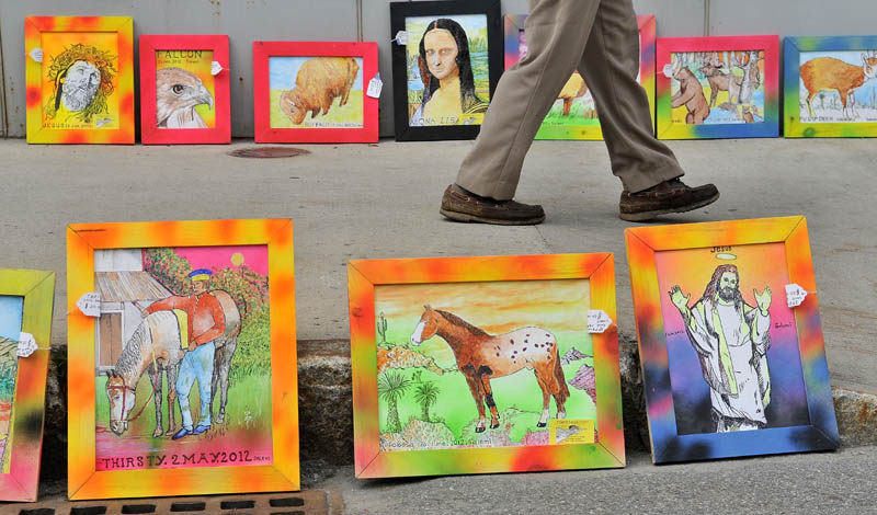 The art work of John Salemi lines the side walk on Main Street in Waterville during the Intown Arts Festival on Saturday.