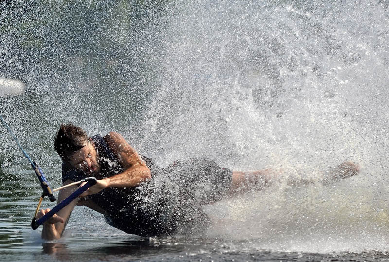 Shane Maroon of Waterville, wipes out during a run on the wake board on Messalonskee Lake in Oakland on Friday morning.