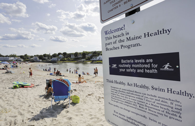 Visitors enjoys the sand and water at Riverside Beach in Ogunquit on Tuesday.