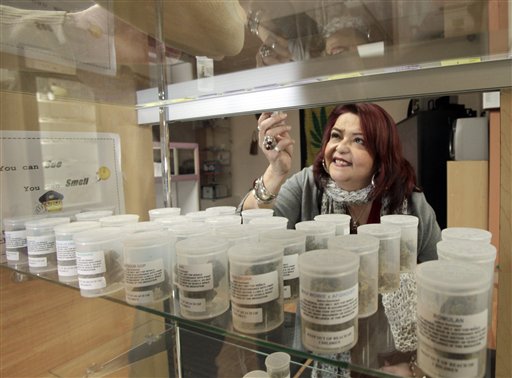 Yamileth Bolanos, who runs Pure Life Alternative Wellness Center, selects a vial of marijuana for a client at her store in Los Angeles in this 2010 photo.