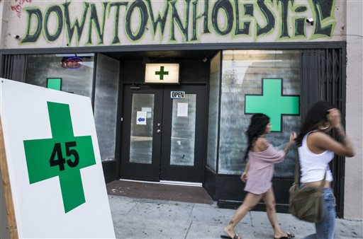 Pedestrians walk past a medical marijuana dispensary in the Echo Park area of Los Angeles on Tuesday.