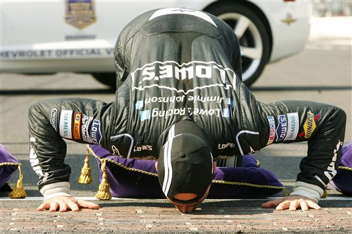 Jimmie Johnson kisses the yard of bricks as he celebrates his win at the NASCAR Sprint Cup Series auto race at Indianapolis Motor Speedway on Sunday in Indianapolis. 2012;Crown Royal presents the Curtiss Shaver 400 at the Brickyard;NASCAR;Practice;Indianapolis Motor Speedway;July;Sprint Cup Series;Indianapolis;Indiana;Autostock