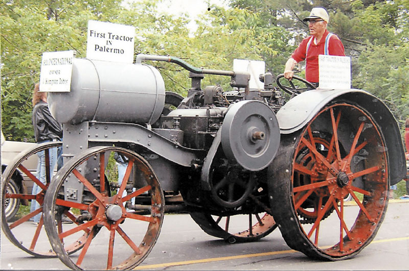 Kempton Tobey sits on this grandfather’s tractor, the first tractor in Palermo.