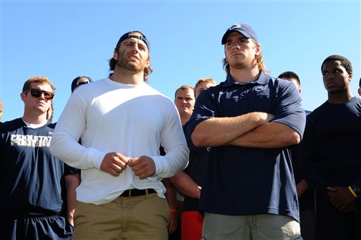 Penn State senior running back Michael Zordich, left, and senior linebacker Michael Mauti give a statement in support of their team, as other players look on Wednesday in State College, Pa.