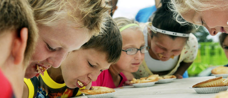 Children consume pie Sunday during a contest to determine who could eat one the fastest during the final day of the Pittston Fair.
