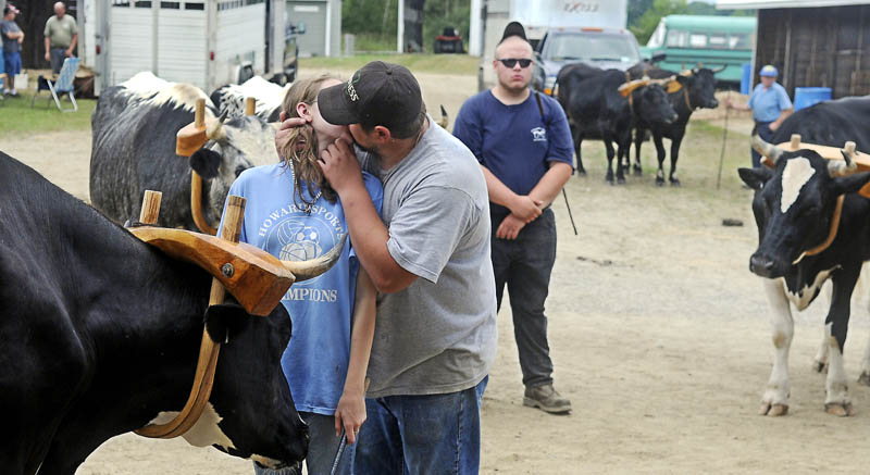 Joseph Couture, of Jay, kisses his girlfriend, Tammy Chase, of Wilton, before she shows her steers Sunday at the Pittston Fair. Several classes of steer and oxen were exhibited on the final day of the agricultural exhibition.