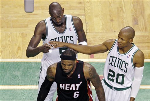 Boston Celtics guard Ray Allen, right, walks behind Miami Heat forward LeBron James in Game 4 of Eastern Conference finals in June. Allen will visit the Heat on Thursday to explore possibly signing with the team. (AP Photo/Charles Krupa)