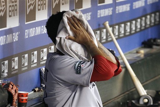 Boston Red Sox starting pitcher Felix Doubront puts a towel on his face in the dugout after he was pulled during the sixth inning of a baseball game against the Texas Rangers, Monday, July 23, 2012, in Arlington, Texas. The Rangers won 9-1. (AP Photo/LM Otero)
