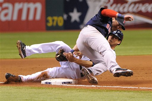 Boston Red Sox third baseman Nick Punto, left, gets the out on Tampa Bay Rays base runner Ben Zobrist to complete the double play during the eighth inning of a baseball game, Friday, July 13, 2012, in St. Petersburg, Fla. (AP Photo/Brian Blanco)