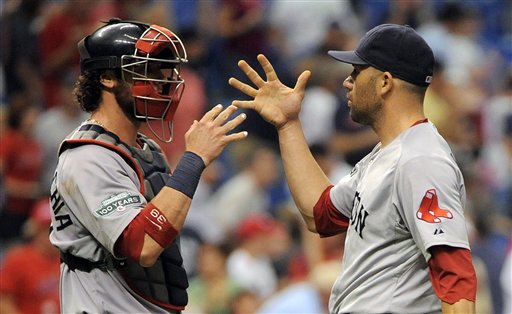 Boston Red Sox catcher Jarrod Saltalamacchia, left, and pitcher Alfredo Aceves celebrate their 7-3 win over the Tampa Bay Rays at the end of a baseball game, Sunday, July 15, 2012, in St. Petersburg, Fla. (AP Photo/Brian Blanco)