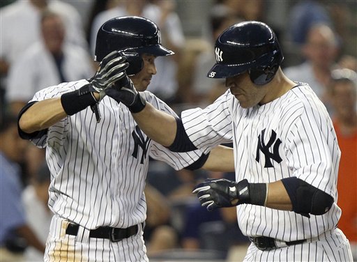 New York Yankees' Russell Martin, right, is greeted by teammate Ichiro Suzuki after hitting a two-run home run during the fourth inning of a baseball game Friday against the Boston Red Sox at Yankee Stadium in New York.